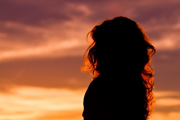 Woman Thinking at Sunrise