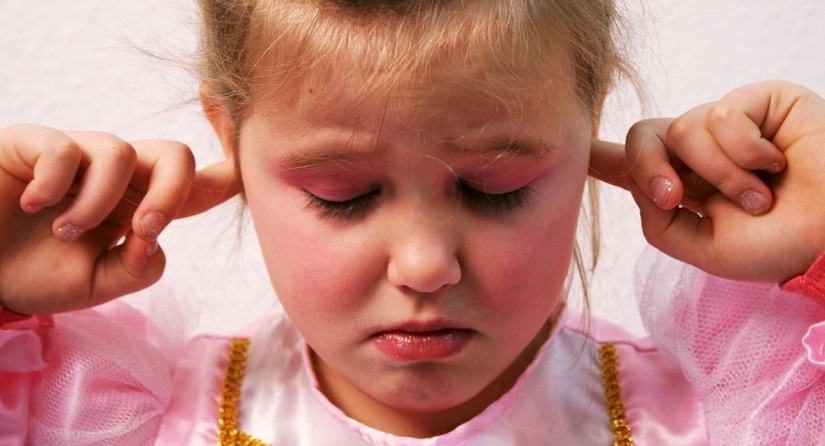 Girl plugging her ears